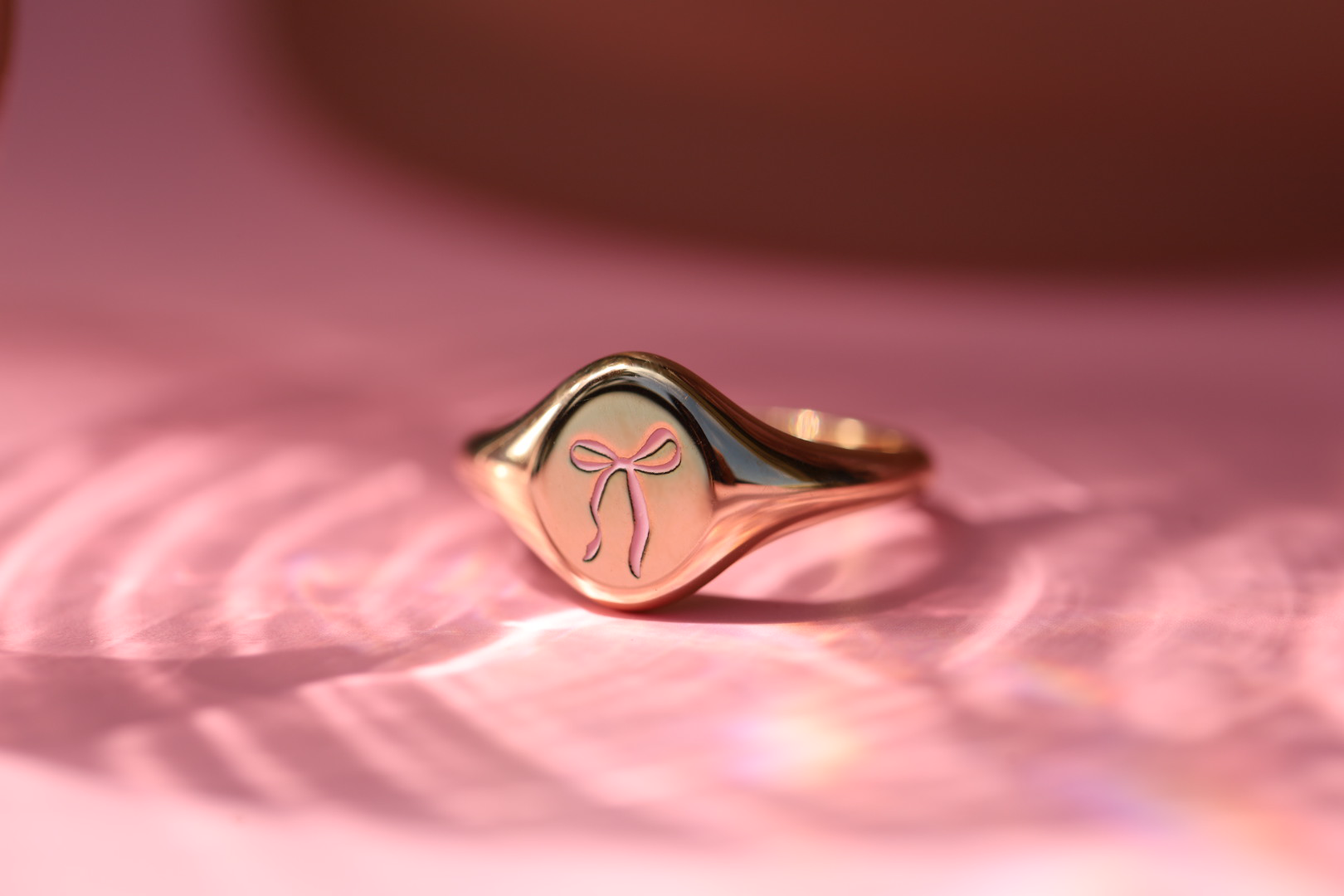 Introducing the Pink Enamel Bow Signet: Supporting Breast Cancer Awareness