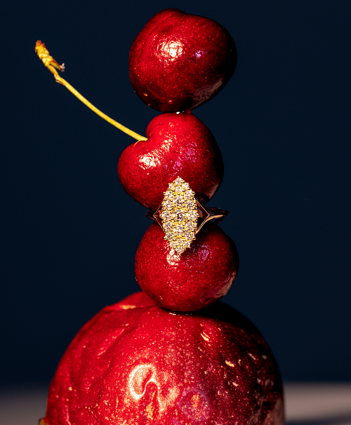 Marrow Fine white diamond ring stacked on red fruit