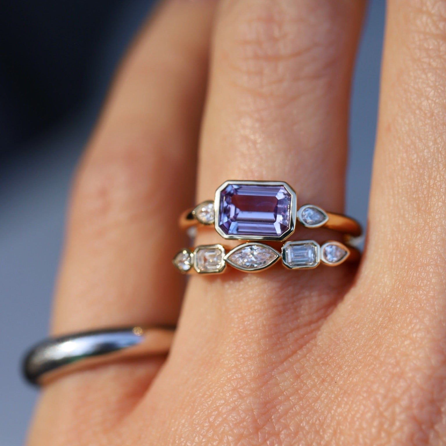 Close up of 1.59ct Sapphire and Diamond Ring with Tracer Band on hand