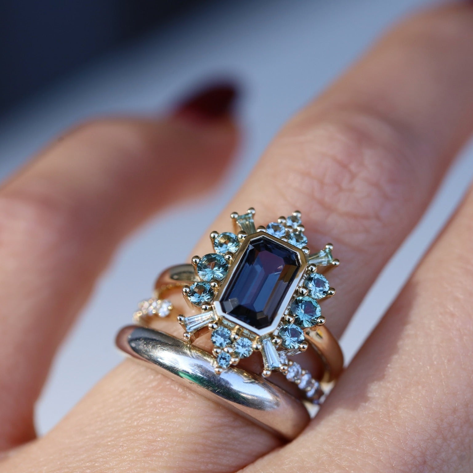 Close up of 2.04ct Spinel and Sapphire Ballerina Ring on hand