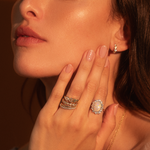 Close up of woman's face with hand resting on her jaw, featuring the 2.40ctOpalandDiamondPetalRing