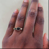 Image of 0.60ct Onyx and Sapphire Linear Band in 14K yellow gold. The main black onyx center stone is bezel set.