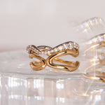 Flat lay of Curved Freeform Gold Ring stacked with the Curved Pavé Diamond Ring