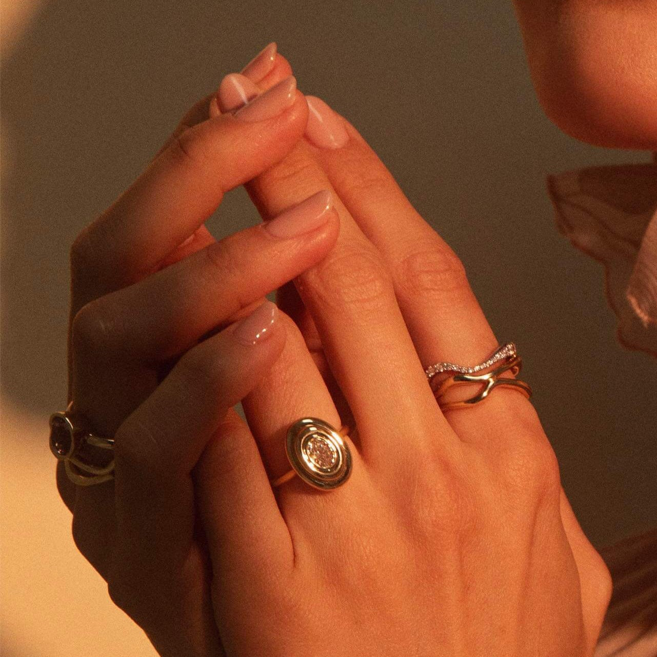 Close up of woman's hand wearing multiple rings - Freeform Gold Ring and Pave White Diamond Ring