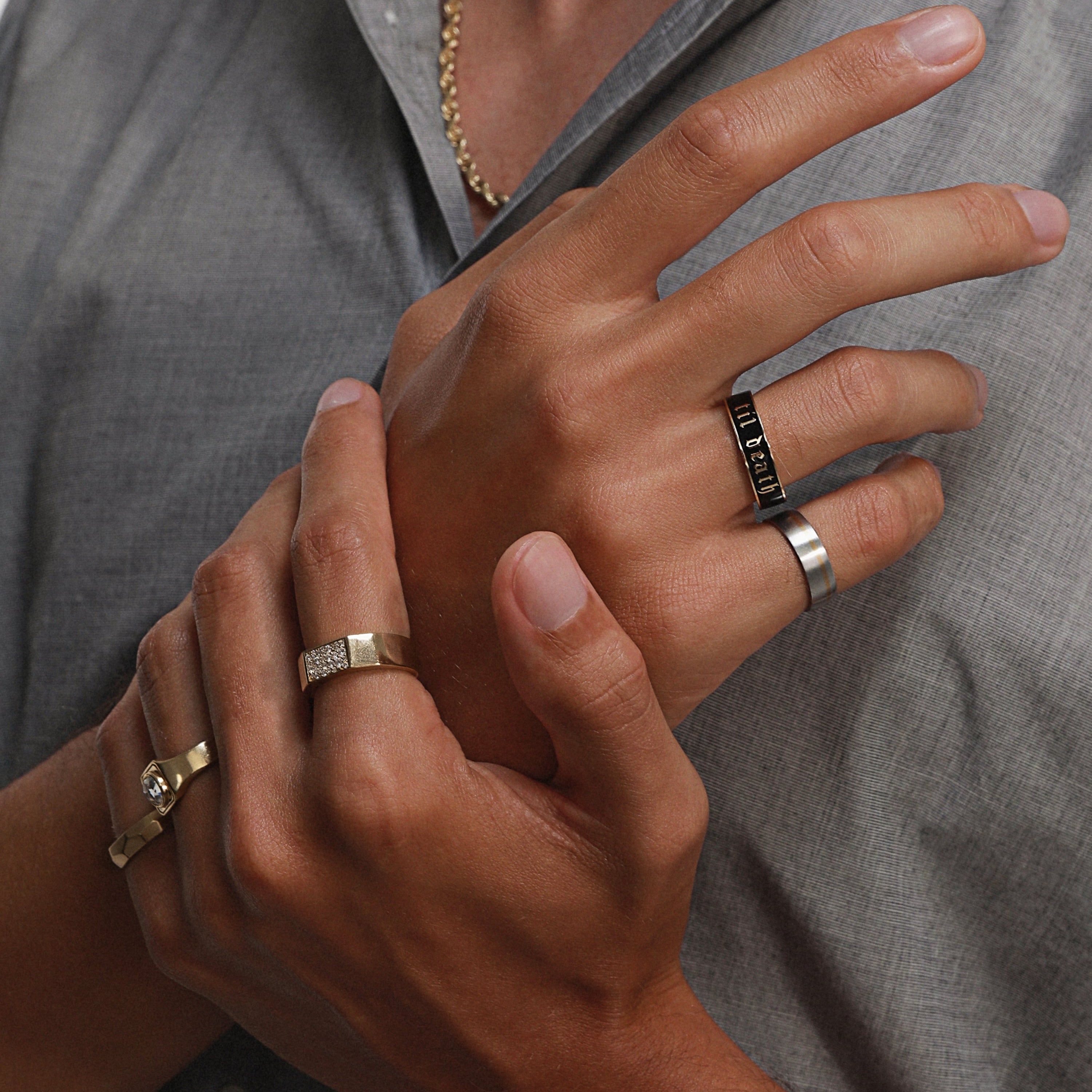 Close up of man's hands wearing multiple Marrow Fine rings