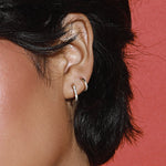 Close up of Mini White Diamond Hoops on ear