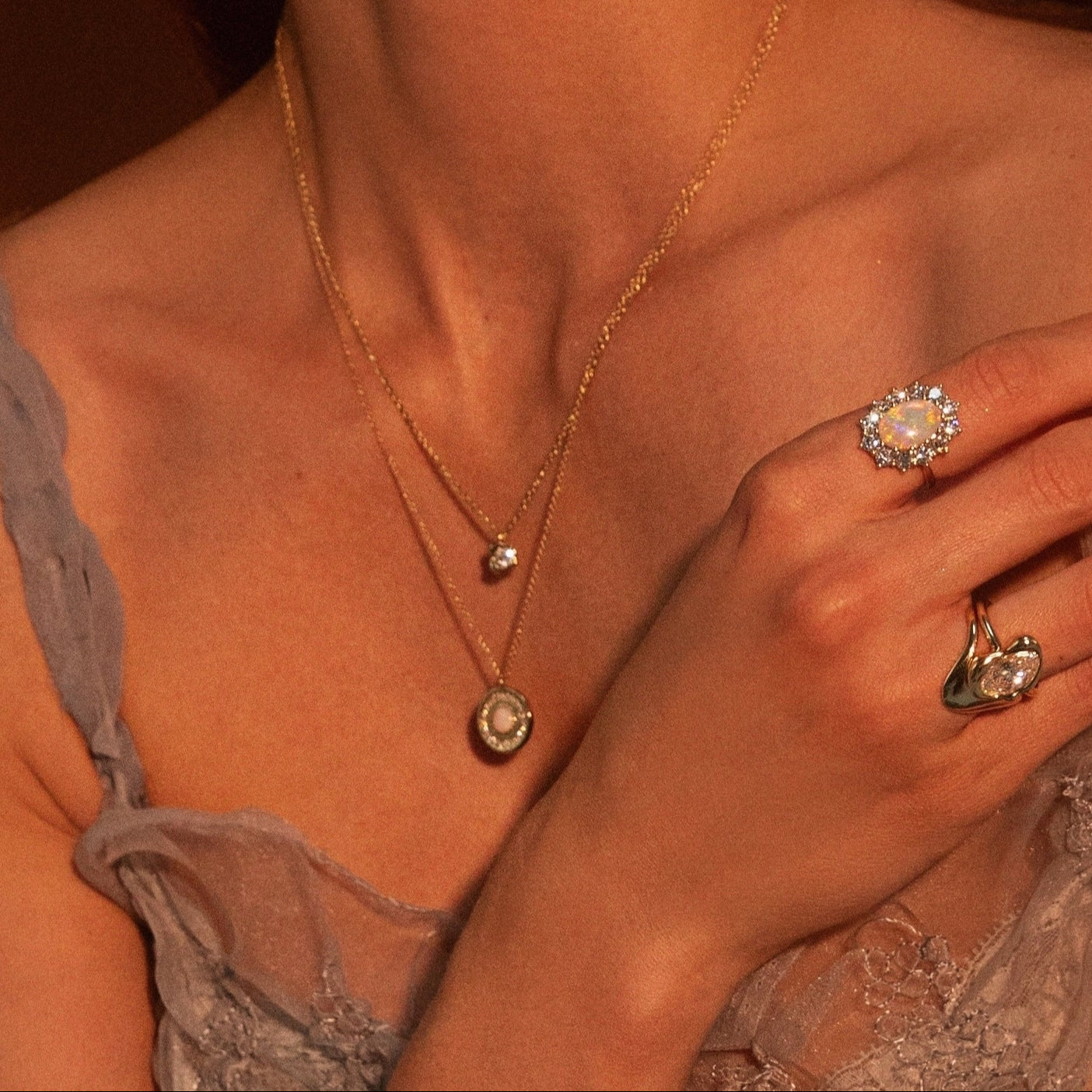 Close up of woman's décolletage wearing the Opal La Femme Amulet