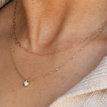 close up of woman's décolletage with multiple Marrow Fine necklaces styled