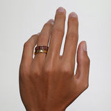 Close up of man's hand wearing the Til Death Cherry Mocha ring in 6mm