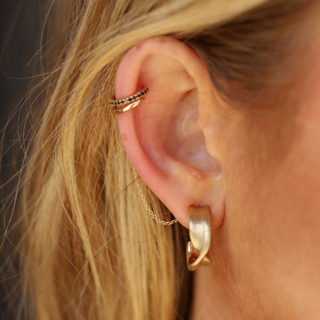 Close up of Everyday Twist Hoops on ear