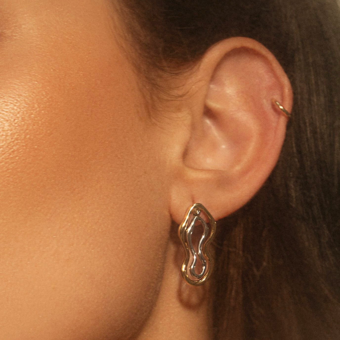 Two Tone Sculptural Freeform Earrings on woman's ear