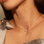 Close up of woman wearing the White Diamond Abstract Bezel Necklace