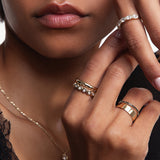 close up of woman with hands resting against her face, featuring multiple Marrow Fine rings styled