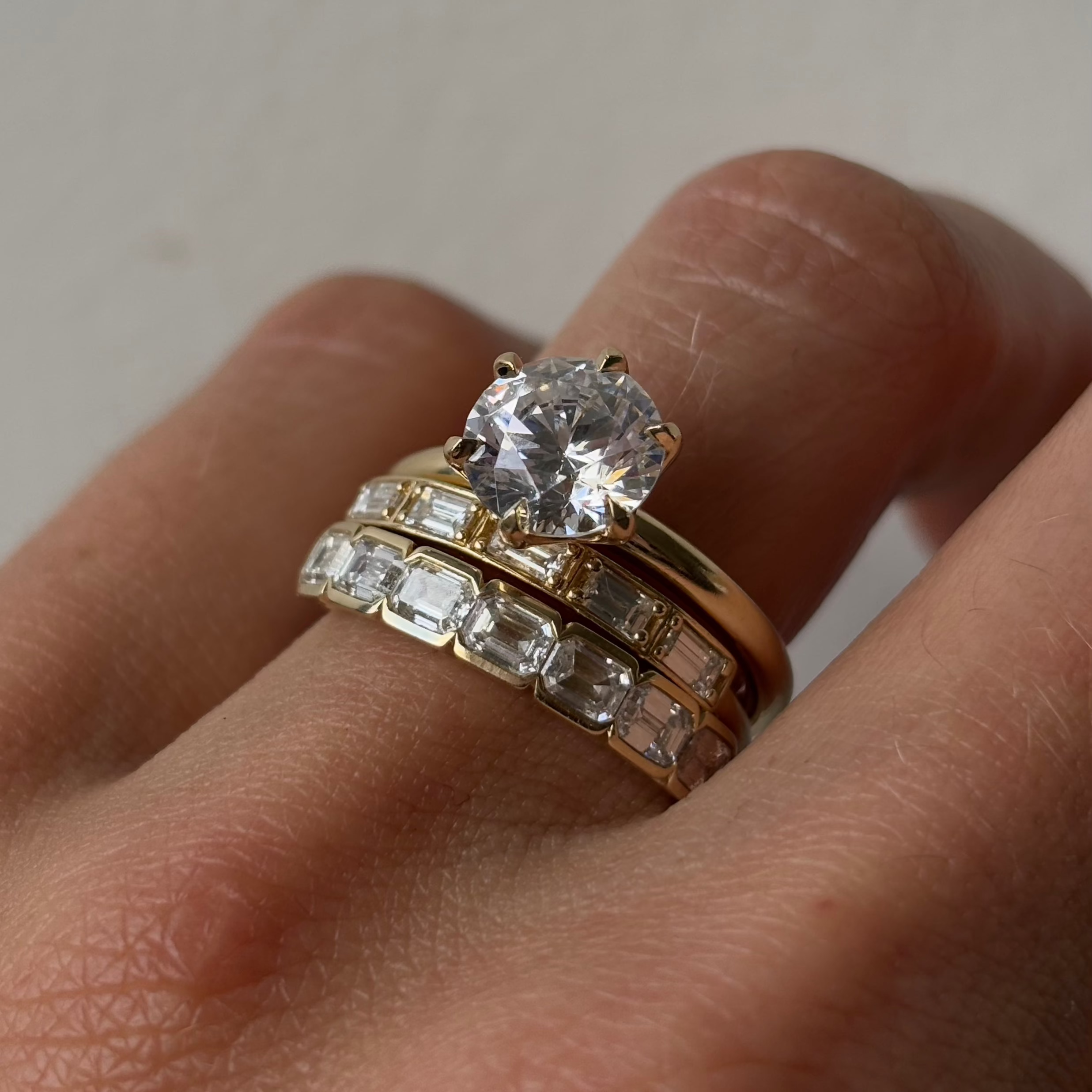 Close up of White Diamond Step Cut Stacking Band styled on finger with other Marrow Fine diamond rings